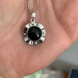 Silver necklace with black/motion pendant